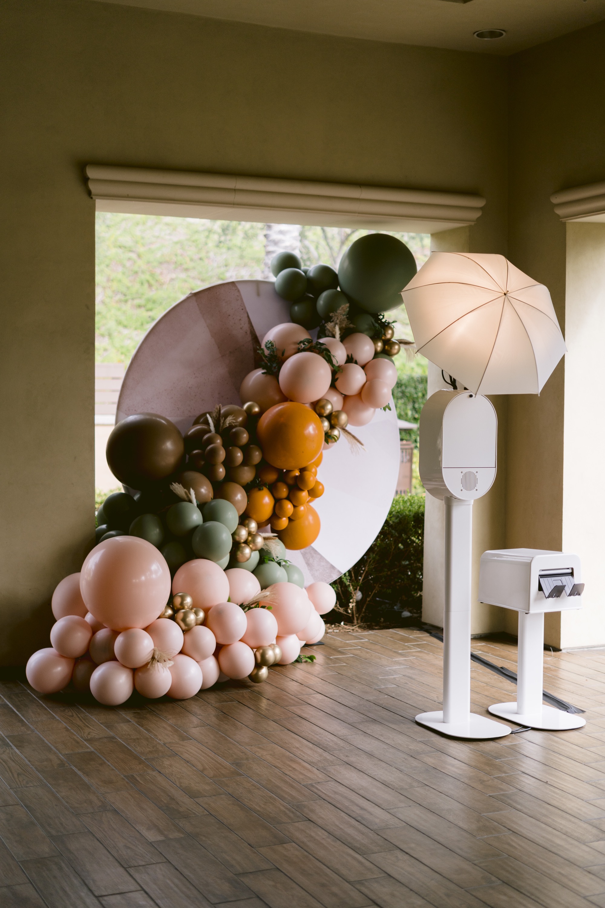 Onyx Photo Booth set up with a colorful balloon arch at an outdoor event