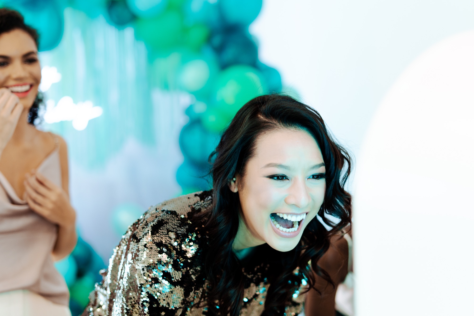 Candid moment of guest laughing at photo booth