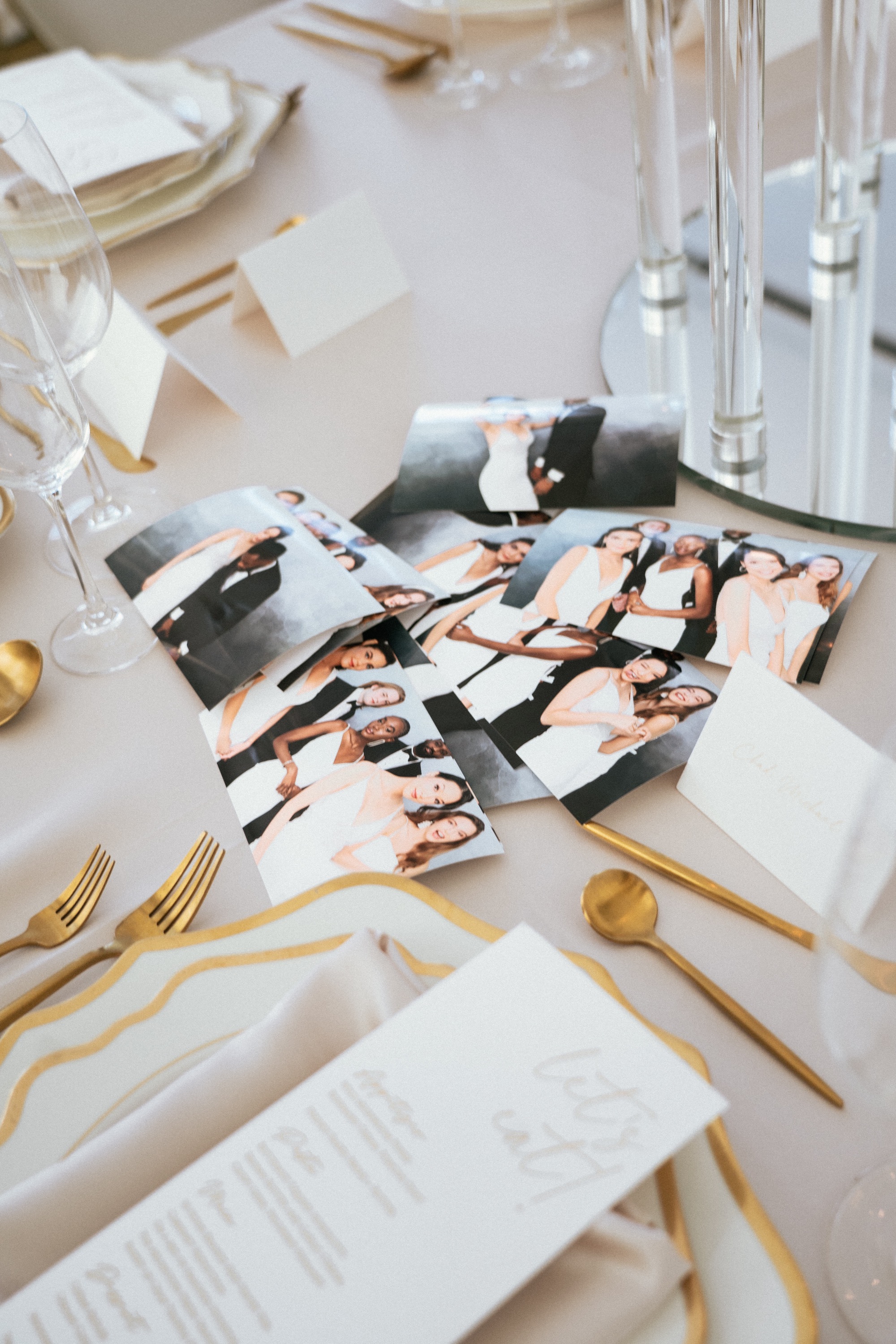 Photo strips on an elegant table with gold flatware