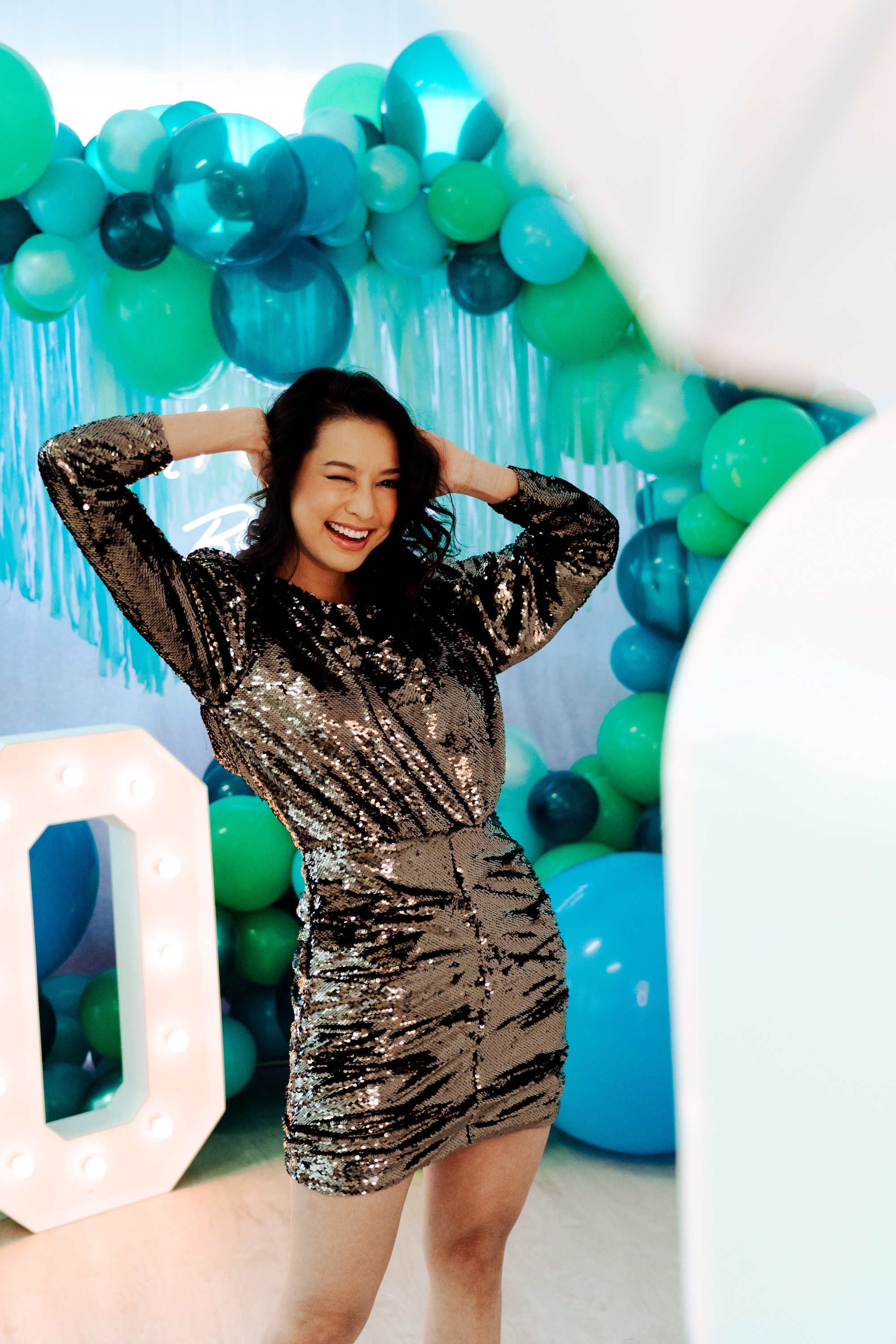Guest in sequin dress posing at the photo booth