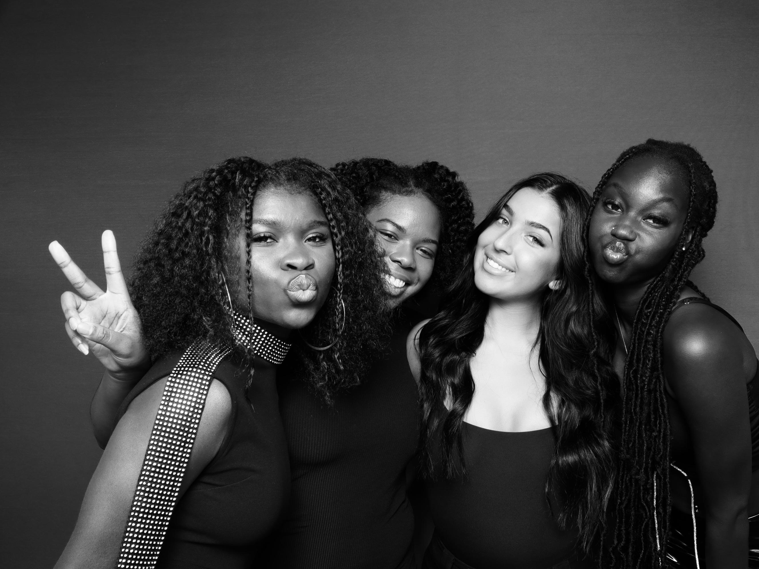 Group of friends posing with peace signs at the Glam Booth