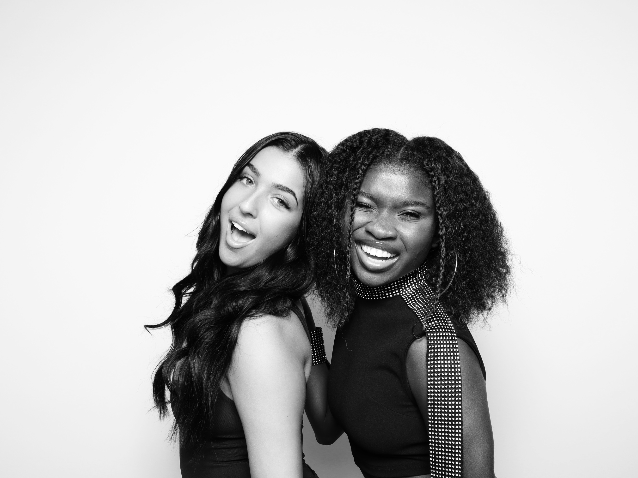 Two best friends laughing at the Onyx Glam Booth